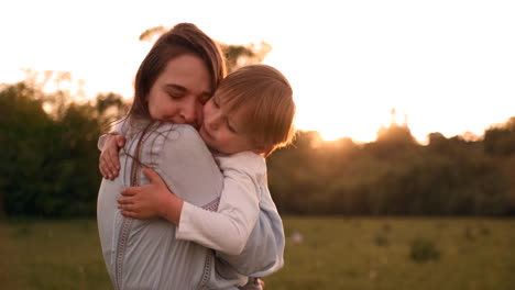 Loving-mother-and-son-hugging-outdoors-sunset.-Loving-mother-and-son-hugging-outdoors-on-sunset-during-their-summer-vacation